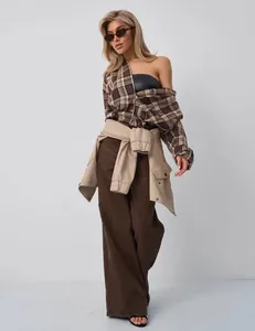 Model wearing an American retro brown plaid shirt styled with a fashionable layered look