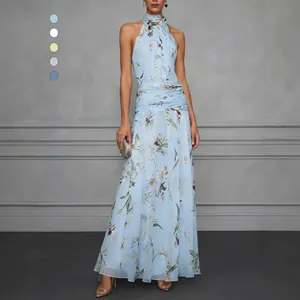 Detail of an elegant light blue floral halter maxi dress with pleated waist detail for women