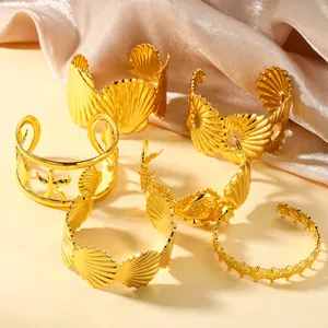 Detailed collection of gold-plated stainless steel cuffs with ocean shell and starfish motifs