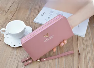 Close-up of a pink faux leather double-zipper long wallet for women with wrist strap