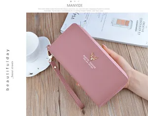Elegant pink leather long wallet for women featuring double zippers and a golden stag logo.