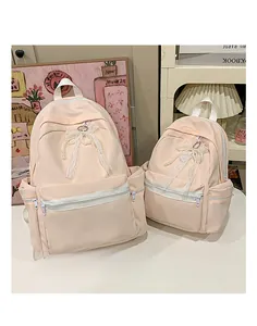 Pink nylon student backpacks with elegant pearl bow decoration in two sizes for girls