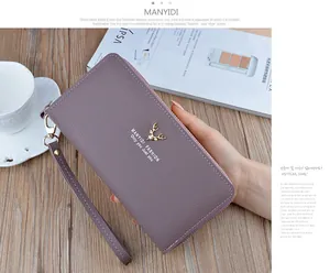 Detailed view of a purple faux leather long wallet with double zippers and wristlet