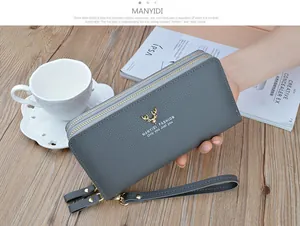 Detail of grey double zipper long leather wallet for women with elegant gold deer logo