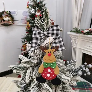 Detailed close-up of a festive reindeer ornament on a snowy Christmas tree branch