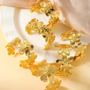 Macro view of polished gold stainless steel floral bracelets showcasing elegant details.