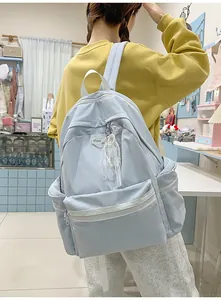Large capacity light blue student backpack for university women in a casual lifestyle setting