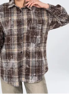 Close-up detail of women's vintage plaid shirt with unique distressed bleached pattern