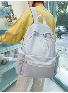 Light blue student backpack for girls with elegant lace bow detail and large capacity.