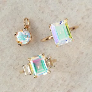 Minimalist gold-plated jewelry set with iridescent square and round opal stones.