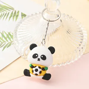 Detailed macro view of a cute cartoon panda keychain holding a black and white soccer ball