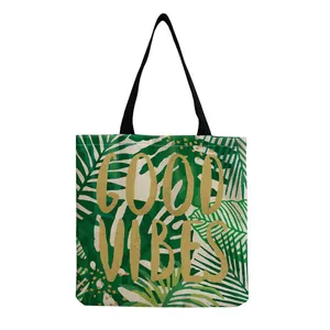 Green tropical leaf print tote bag with gold Good Vibes lettering details