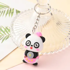 Detailed view of a cute cartoon panda keychain holding a small frying pan