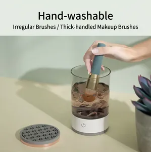 Detailed view of handheld electric makeup brush cleaner being used in a water tank.