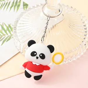 Close-up detail of a cute cartoon panda keychain with a red shirt and yellow racket