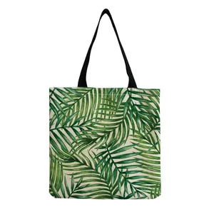 Canvas shopping tote bag with tropical green palm leaf print and black shoulder straps