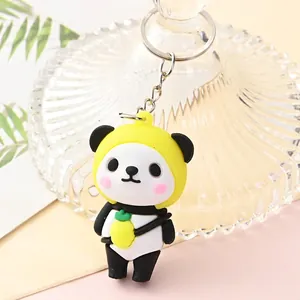 Close-up of a cute cartoon panda keychain with yellow hood and pineapple detail