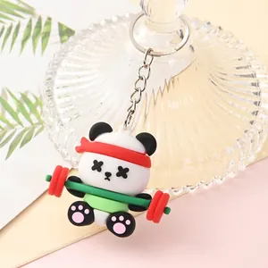 Close-up of a cute cartoon panda keychain lifting weights and wearing a red headband