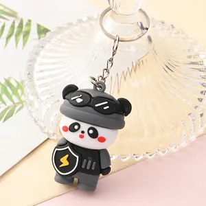 Close-up detail of a cute cartoon panda keychain wearing grey tactical gear and goggles