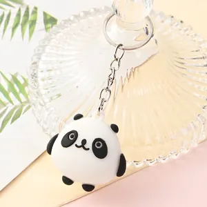 Close-up of a cute cartoon panda keychain with a silver metal ring.
