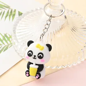Adorable cartoon panda keychain featuring a yellow bow and a cute milk tea cup accessory