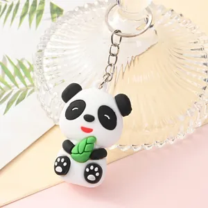 Close-up of a cute 3D cartoon panda keychain pendant holding a green leaf in soft silicone