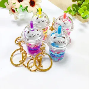 Detailed view of four colorful sakura cat milk tea cup keychains with liquid