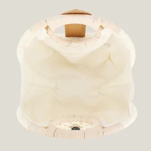 Interior view of a woven shell handbag made of natural paper rope with fabric lining.
