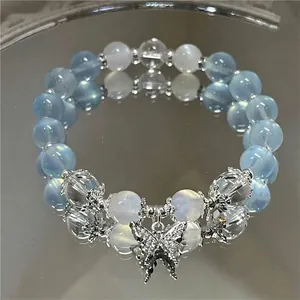 Exquisite blue and white beaded butterfly bracelet for women on a reflective mirror