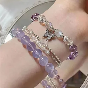 Exquisite layered purple and lavender beaded bracelet set featuring a silver butterfly charm