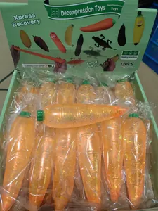 Colorful carrot-shaped maltose glitter squeeze stress balls in a 12-piece retail display box