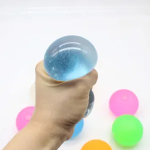 Detailed close-up showing a hand squeezing a blue maltose syrup stress relief ball toy.