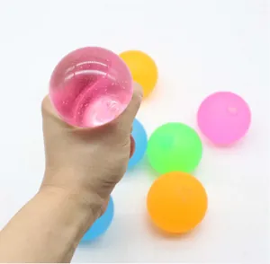 Close-up detail of hand squeezing a translucent pink maltose squishy stress ball