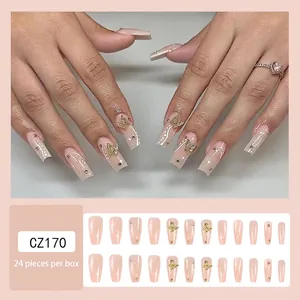 Close-up of golden butterfly press-on nails set with 24 pieces