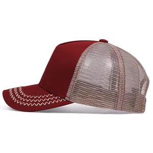 Side view of vintage burgundy trucker hat with breathable beige mesh and zigzag stitching.