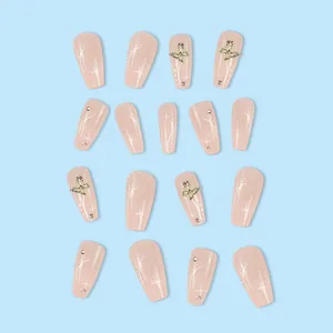 Elegant nude press-on nails with gold butterflies, rhinestones and star patterns.