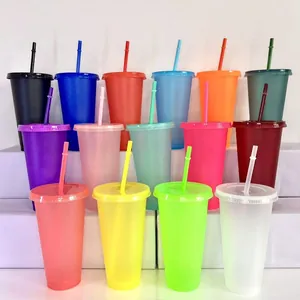 Detail view showing a variety of colorful 24oz glitter plastic tumblers with matching straws