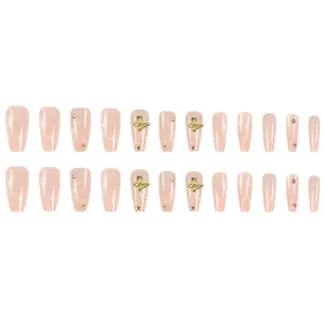 Full set of nude press-on nails with 3D gold butterflies and shiny rhinestones.