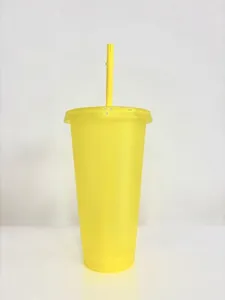 Side view of a 24oz semi-transparent yellow glitter plastic cup with a straw.