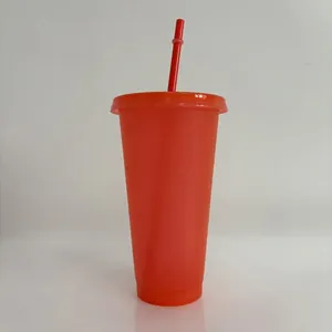 Close-up of a 24oz red glitter plastic tumbler with a matching straw.