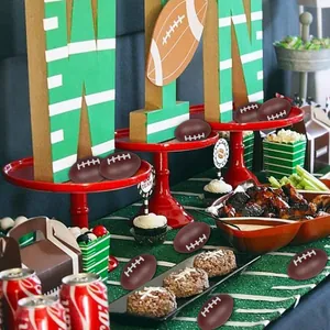 Mini American football stress balls scattered on a sports-themed party snack table.