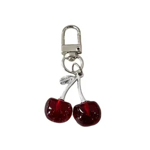 Adorable glittery red cherry keychain accessory with a sturdy silver-toned metal D-clasp