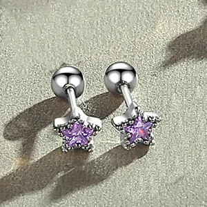 Detail of purple star-shaped screw back earrings crafted in polished stainless steel