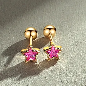 Close-up of gold screw-back stud earrings with pink star-shaped crystals for women.