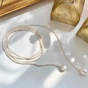 Close-up of elegant handmade freshwater pearl necklace with large pearl tassels