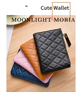 Detail of quilted mini zip wallets in four elegant colors on light wood background