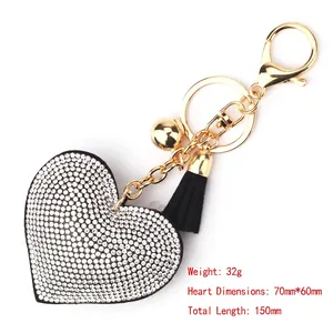 Detailed view of a rhinestone heart keychain featuring a black tassel and dimensions