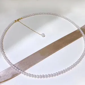Close-up view of a minimalist freshwater pearl necklace with a single pearl tassel pendant.