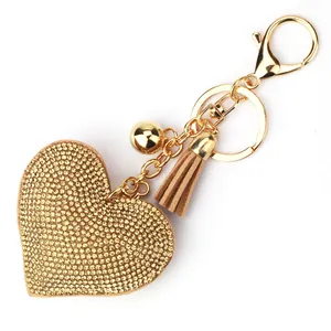 Elegant heart-shaped keychain with golden rhinestones and stylish leather tassel
