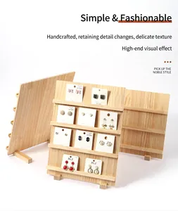 Close-up of tiered natural wood display stands showcasing multiple earring cards